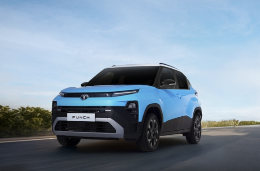 Premium Kaveri Tata dealership showroom with Tata cars and customer service representatives assisting buyers